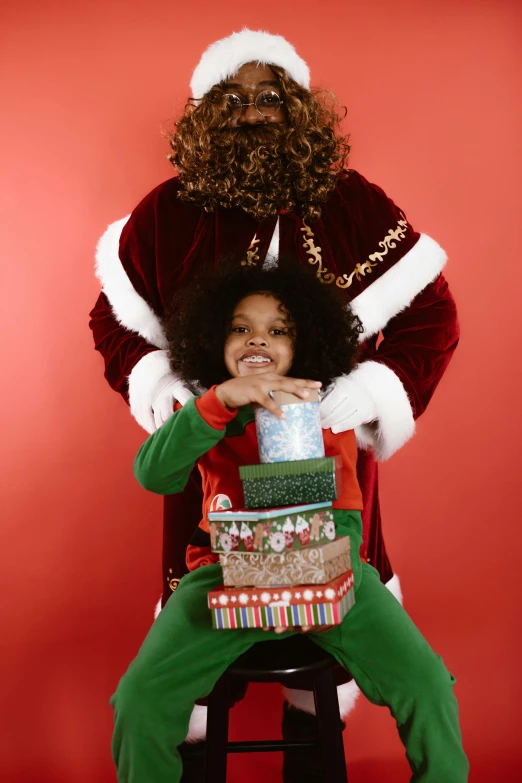 a small child sitting on the lap of a father christmas santa