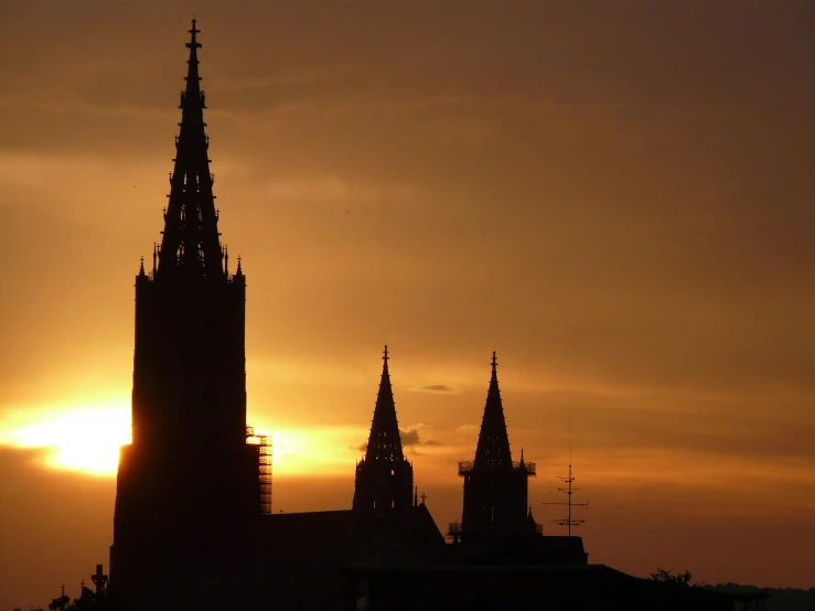 the sun is setting behind a very tall building, pexels contest winner, baroque, majestic spires, brown, thumbnail, nd 4