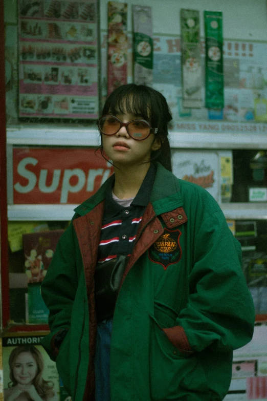 a young man is standing in front of a convenience store