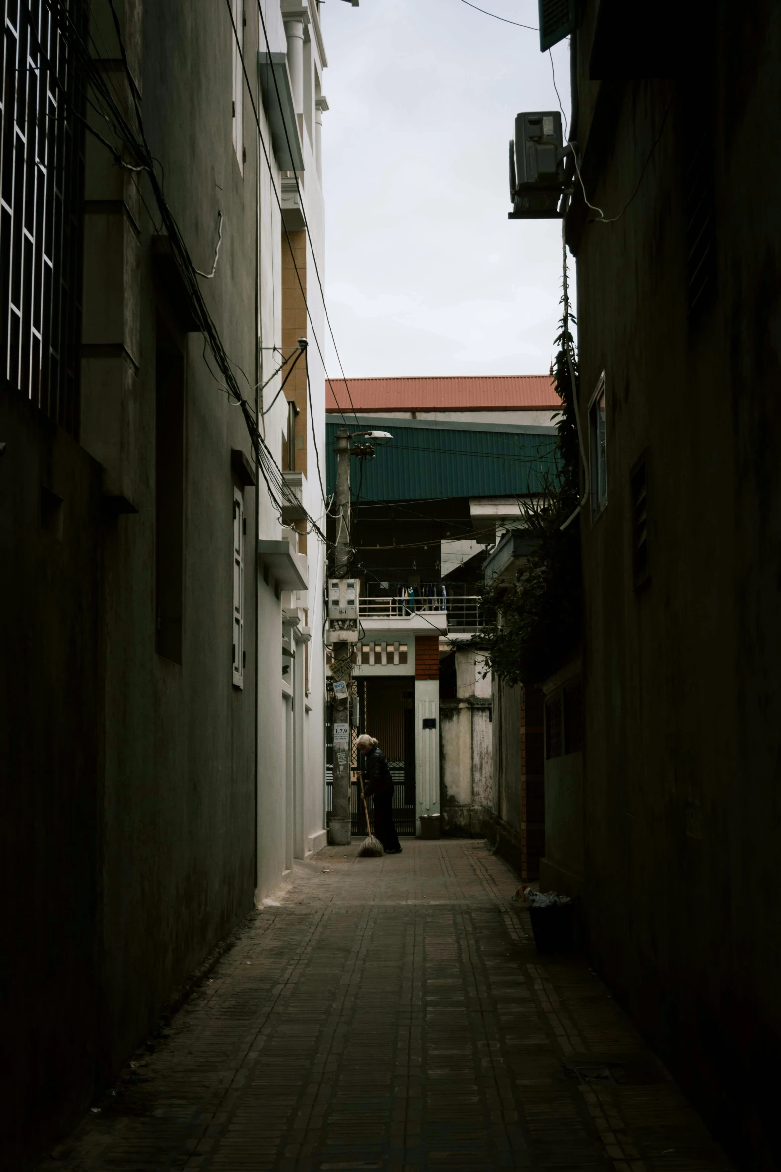 a person walking down a narrow alley way, bao phan, view from a distance, mysterious exterior