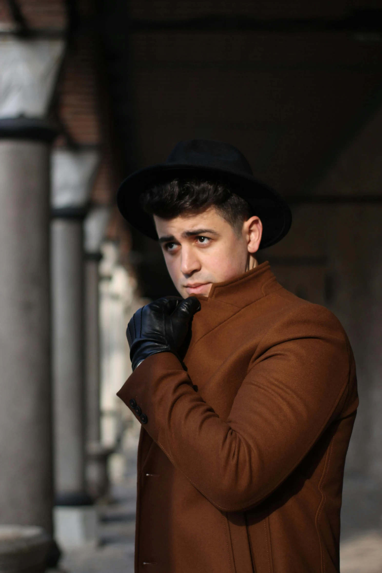 a man in a brown coat and black gloves, an album cover, inspired by Carlo Mense, pexels contest winner, portrait of a young italian male, mimmo rottela, lgbtq, street pic