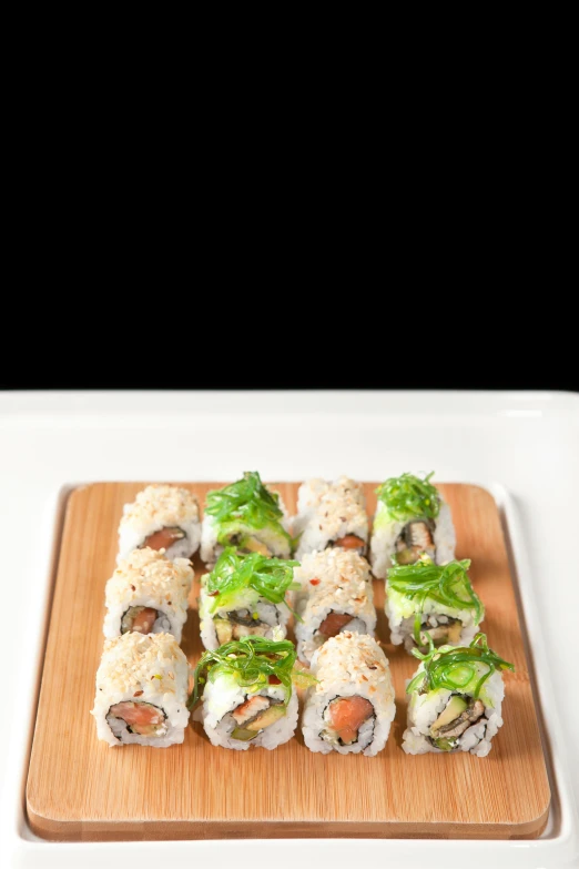 several sushi rolls are on a  board