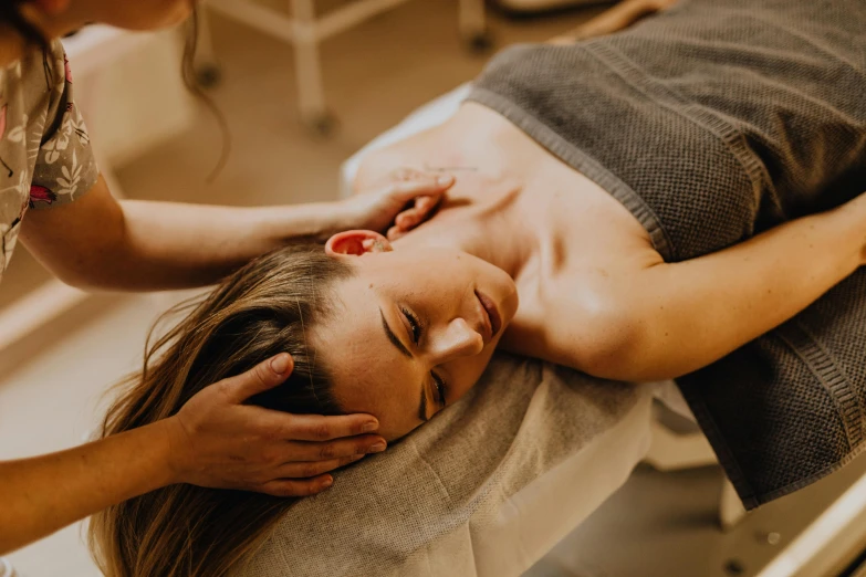 a woman getting a massage at a spa, unsplash, manly, thumbnail, enhanced, cast