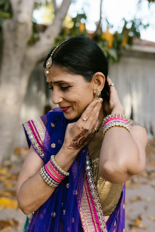 a woman in a blue sari talking on a cell phone, a tattoo, pexels contest winner, renaissance, 2 5 6 x 2 5 6 pixels, wearing ornate earrings, intricate wrinkles, wedding