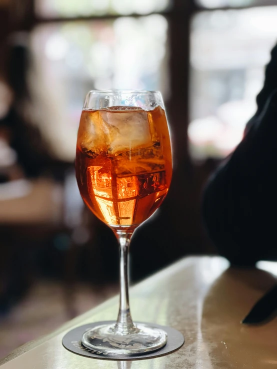 a wine glass filled with ice on top of a table