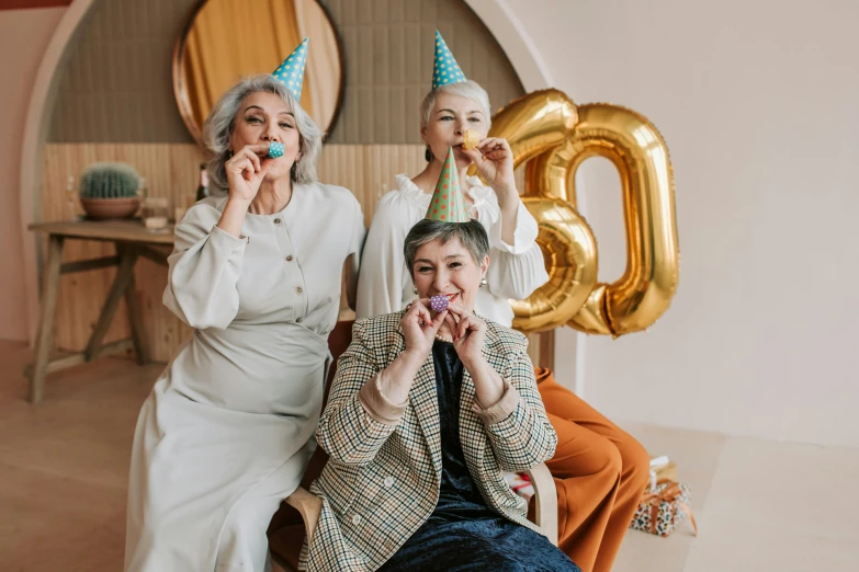 a couple of women sitting next to each other, by Emma Andijewska, pexels contest winner, pals have a birthday party, 3 - piece, wrinkles, holding a balloon