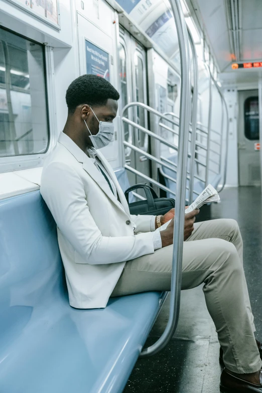 a man wearing a face mask on a subway train, pexels contest winner, renaissance, wearing white suit, reading, african american, looking hot