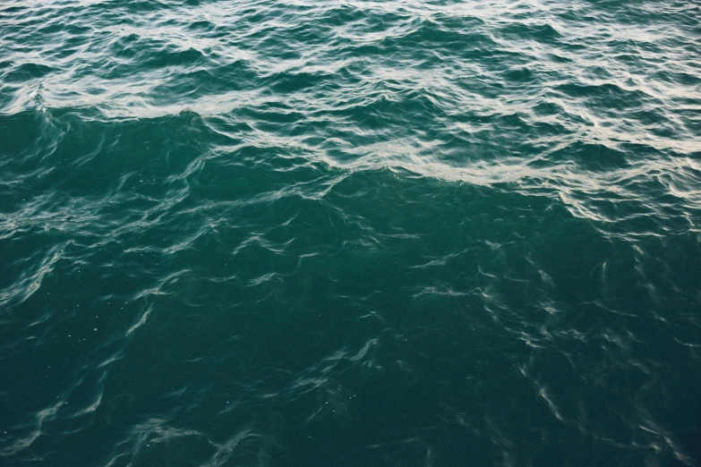 a person riding a surfboard on top of a body of water, a picture, by Elsa Bleda, hurufiyya, dark green water, currents, deep blue, made of water