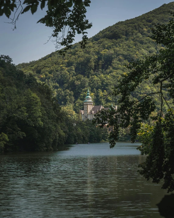 there is a church in the background from the lake