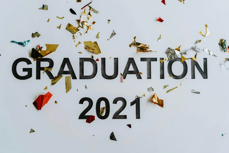 a sign that says graduation 2021 surrounded by confetti, trending on pexels, background image, kacper niepokolczycki, high gradient, embroidered robes