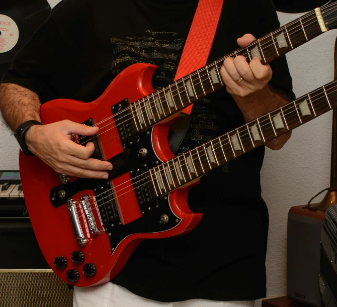 a man in a black shirt holding a red guitar, pexels contest winner, with a twin, bumpy skin, electric guitars, avatar image