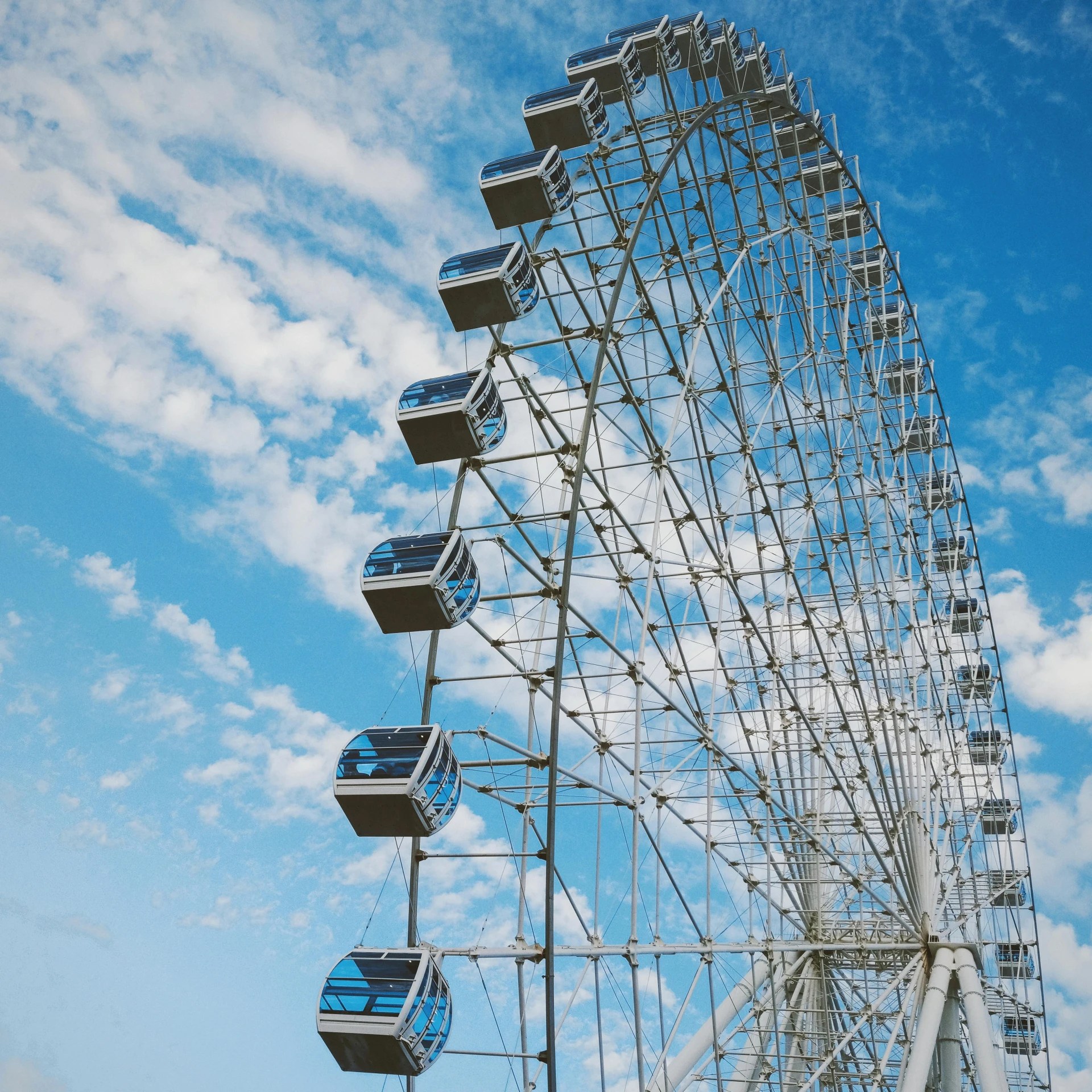 the large ferris wheel is high up in the sky