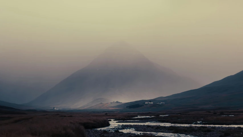 this landscape shows hills, a creek and a sky