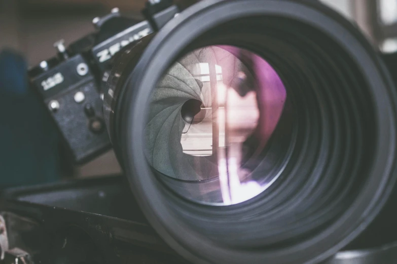 a camera lens sitting on top of a piece of luggage, pexels contest winner, photorealism, looking into camera, reflective lens, zoomed in shots, 4k headshot photography