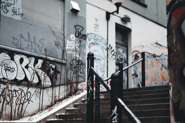 a set of stairs covered in graffiti next to a building, by Christen Dalsgaard, pexels contest winner, winter vibes, old comics in city, thumbnail, 90's photo