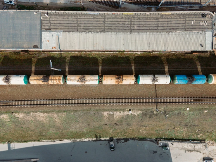 train cars sit side by side near train tracks