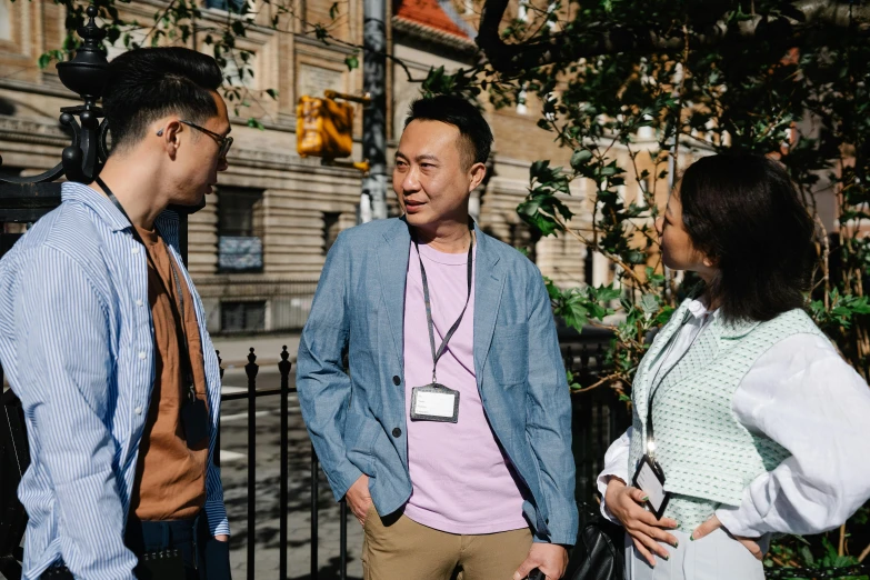 a group of people standing next to each other, by Nina Hamnett, pexels contest winner, asian man, nyc, talking, promotional image