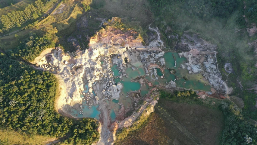 an aerial s shows several rocks, water and trees