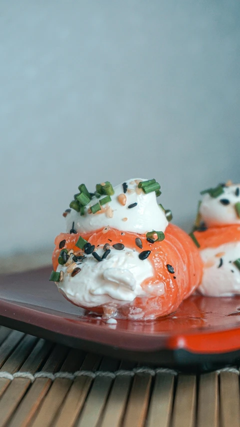 a close up of a plate of food on a table, whipped cream, sushi, thumbnail, bulbous