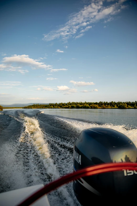 a motor boat traveling across a body of water, by Roar Kjernstad, full frame image