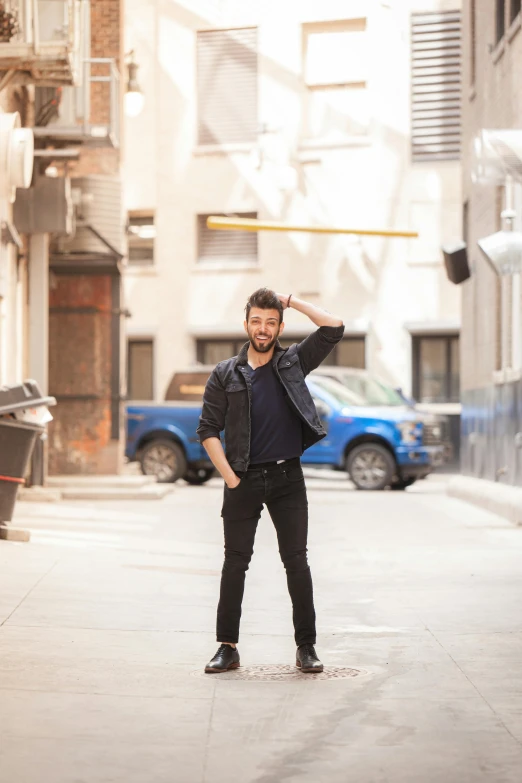 a man on the road holding his hand up to his ear