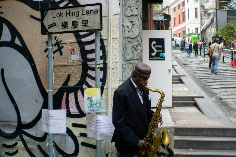 there is a man playing on a saxophone