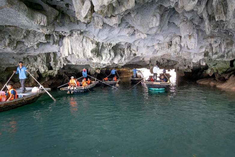 a group of people in small boats in a cave, maintenance photo, fan favorite, lê long, unedited