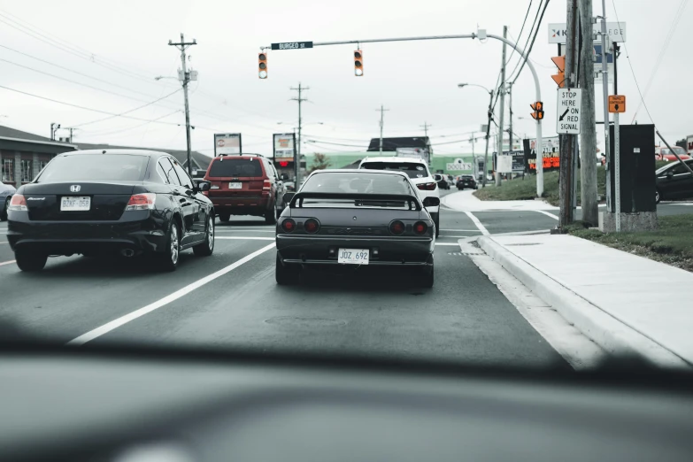 a bunch of cars that are sitting in the street, an album cover, unsplash, traffic signs, japanese drift car, low quality photo, shot on sony a 7