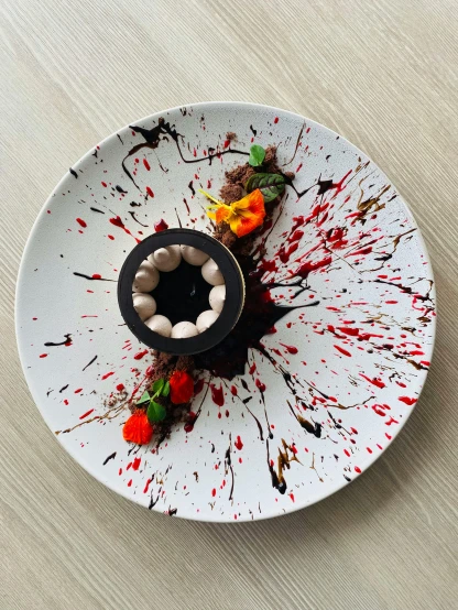 a close up of a plate of food on a table, inspired by Anish Kapoor, pexels contest winner, process art, blood splatter on the sides, fully chocolate, adorable design, taken on iphone 14 pro