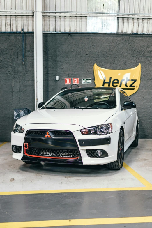 an all white sport car on display inside of a garage