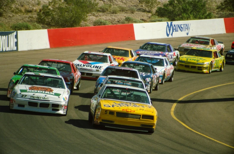 a group of cars driving on top of a race track