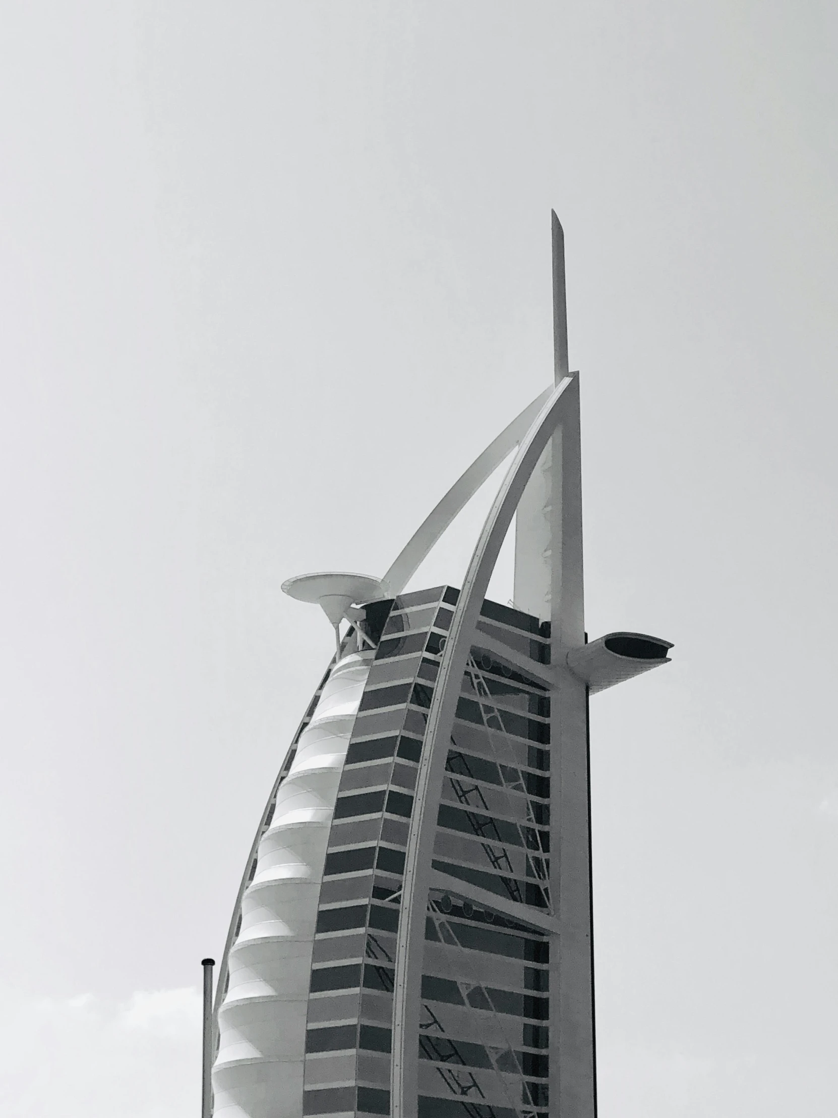 an architecturally designed building has tall, curved roof beams