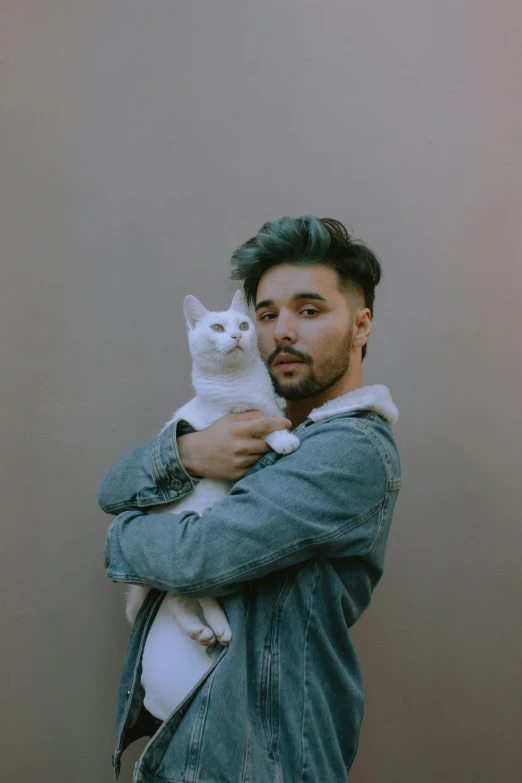 a man with a cat in his arms