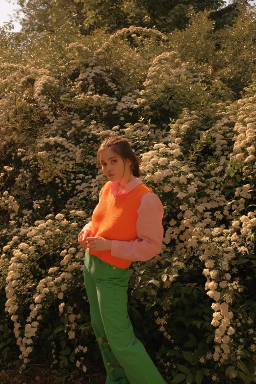 a woman running with a frisbee in her hand, an album cover, trending on pexels, color field, orange flowers, wearing a green sweater, ((neon colors)), pokimane