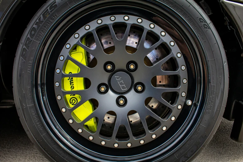 a close up of a tire on a car, black armor with yellow accents, deep dish wheels, portrait of jerma985, kevlar