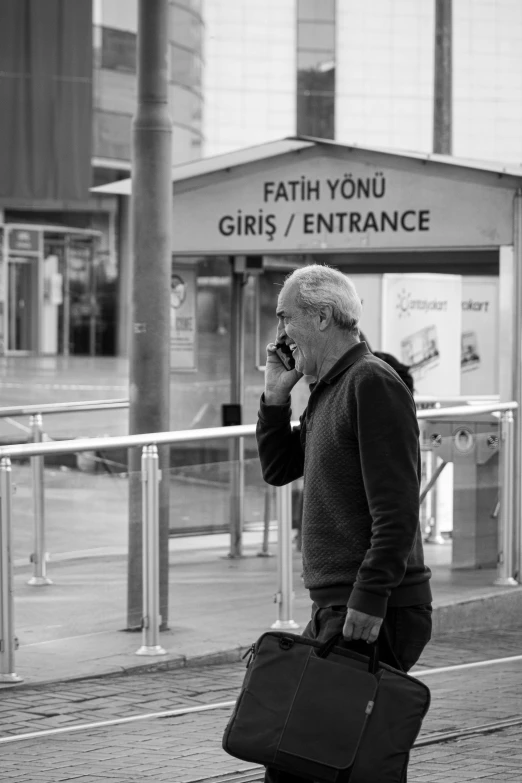 a man walking down the street talking on a cell phone, a black and white photo, by Colin Gill, white haired lady, faith, bus station, girl making a phone call