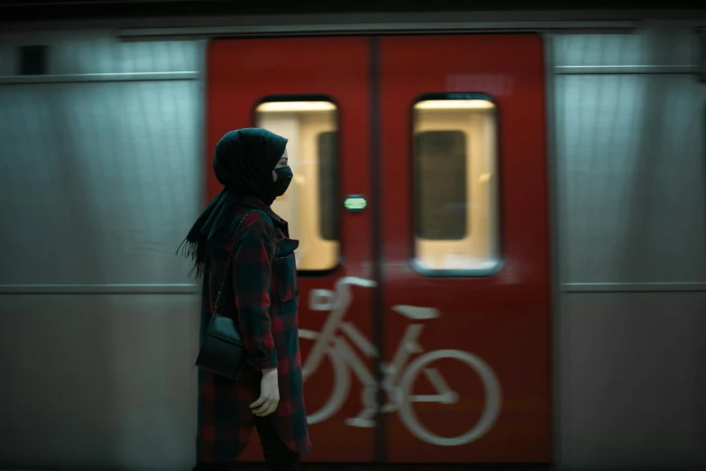 man standing in front of a subway train