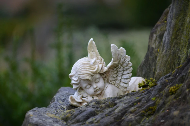 a statue of an angel resting on a rock, high quality product image”, shot on sony a 7, putti, delightful surroundings