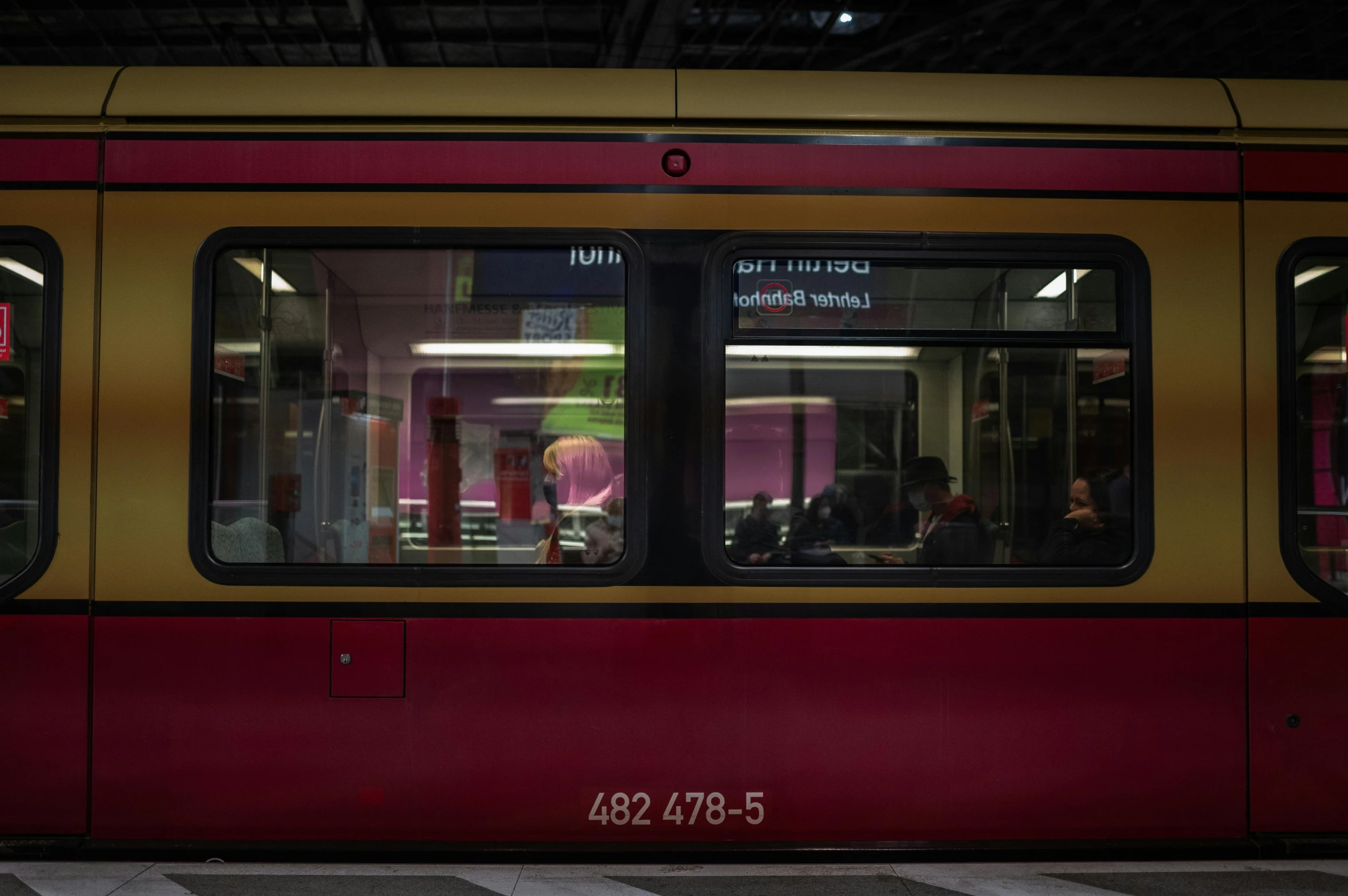 a red and yellow train at a train station, by Tobias Stimmer, street tram, barely lit warm violet red light, glasgow, thumbnail