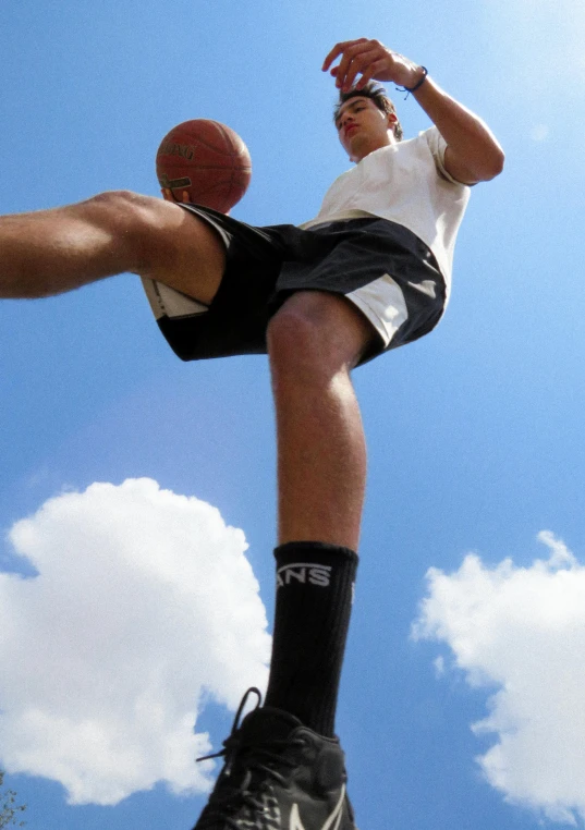 a man flying through the air while holding a basketball, dribble, knee high socks, taken in the late 2000s, promo image, towering