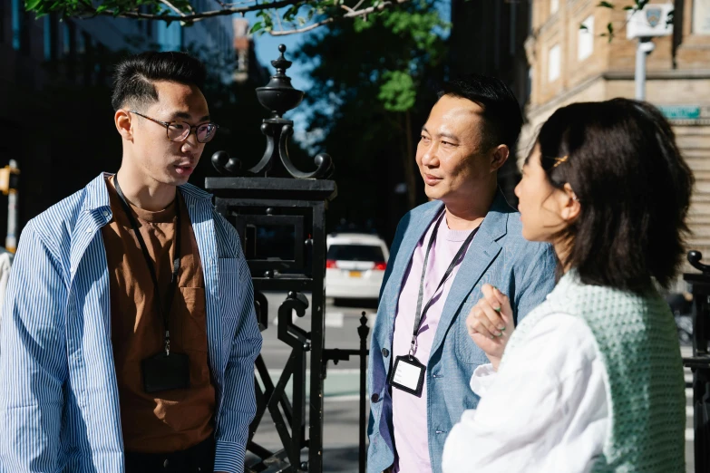 a group of people standing next to each other, pexels contest winner, ngai victo and dougherty patrick, talking, in city street, darren quach