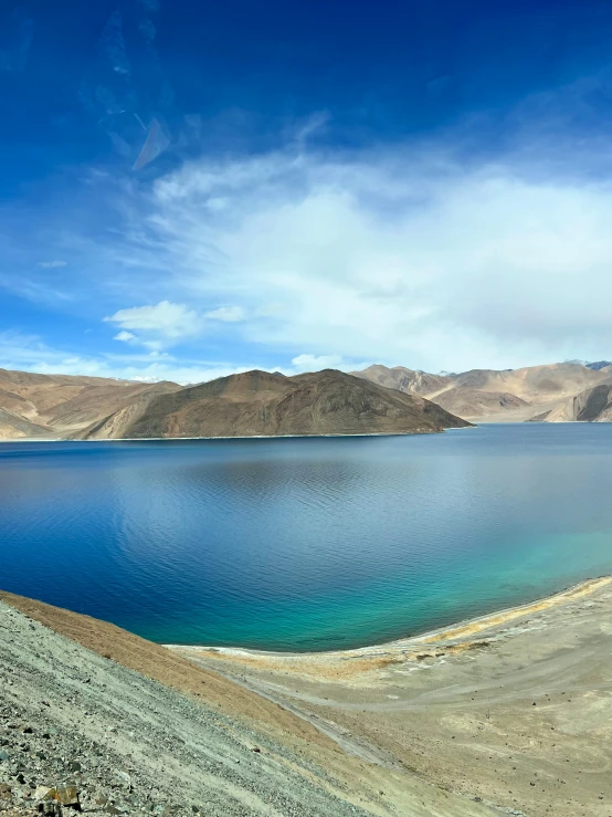 a body of water with hills in the background