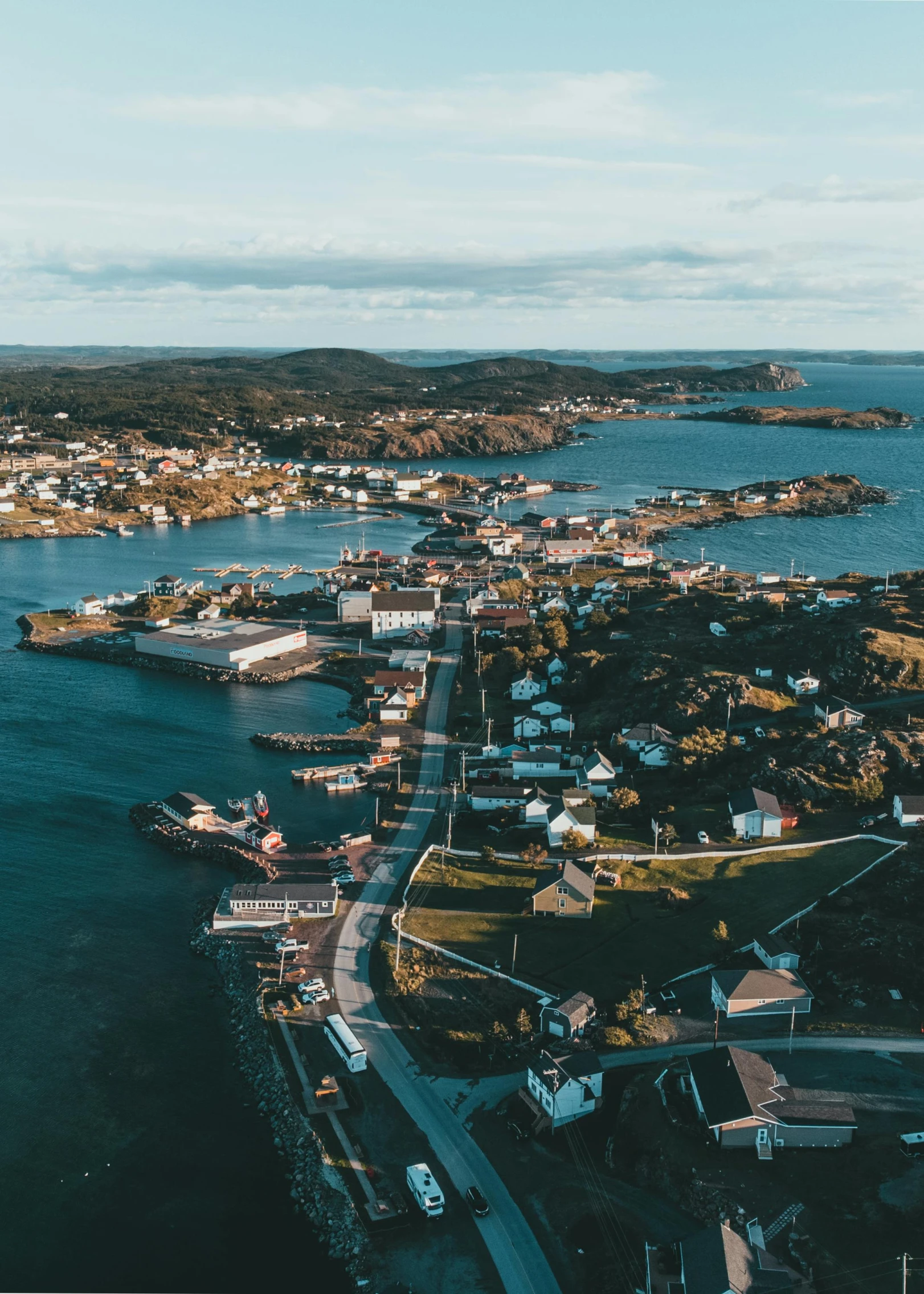 a large body of water next to a small town, by Jesper Knudsen, pexels contest winner, happening, archipelago, view of the ocean, brown, notan