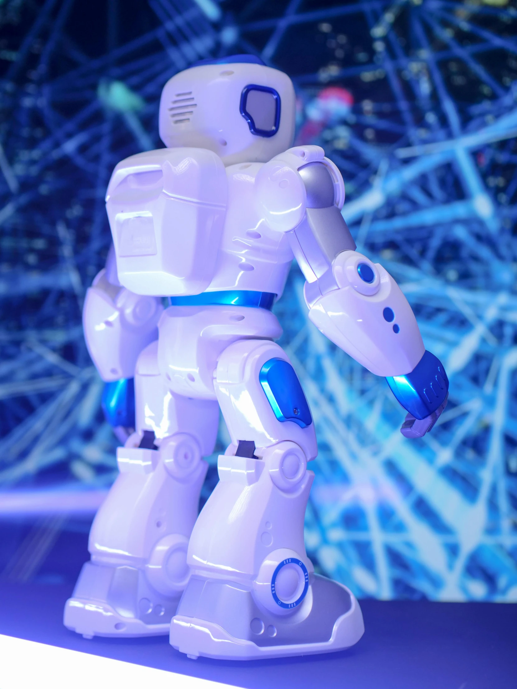 a close up of a toy robot on a table, a hologram, walking towards the camera, promo image, siggraph, < full body robot >