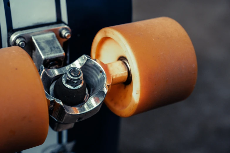 a close up of a skateboard with orange wheels, by Jakob Gauermann, pexels contest winner, bauhaus, leaking pistons, caramel, 15081959 21121991 01012000 4k, bead and reel