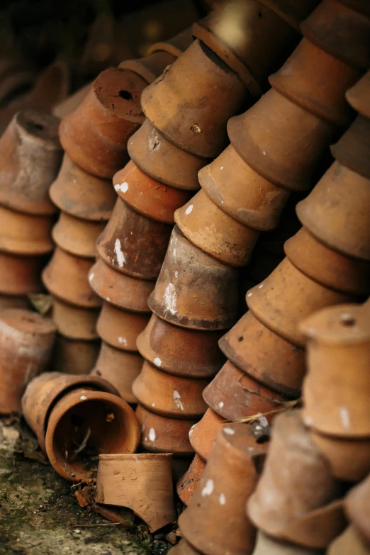 a bunch of clay pots stacked on top of each other, an album cover, unsplash, rusty pipes, cone heads, springs, deep texture