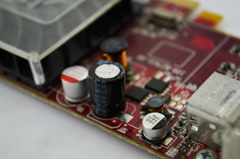 a close up of a small electronic device, crimson themed, assembled, engineering, wide shot photograph