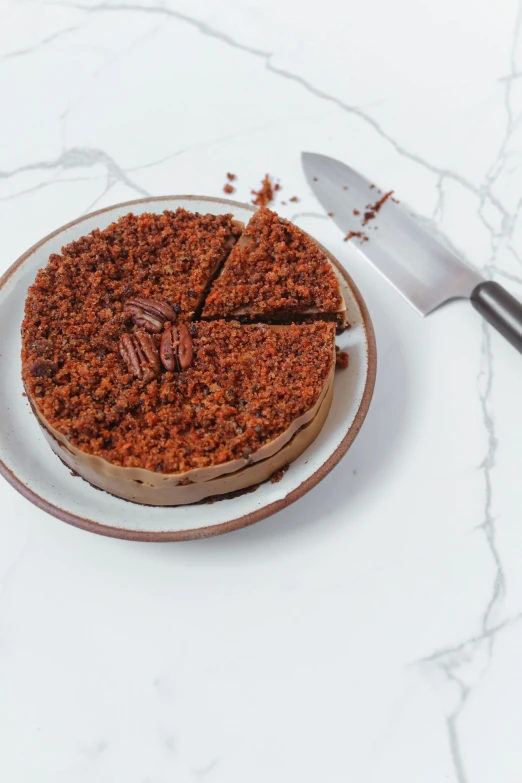 a piece of cake on a plate with a knife, product image, ground level shot, brown:-2, sunday