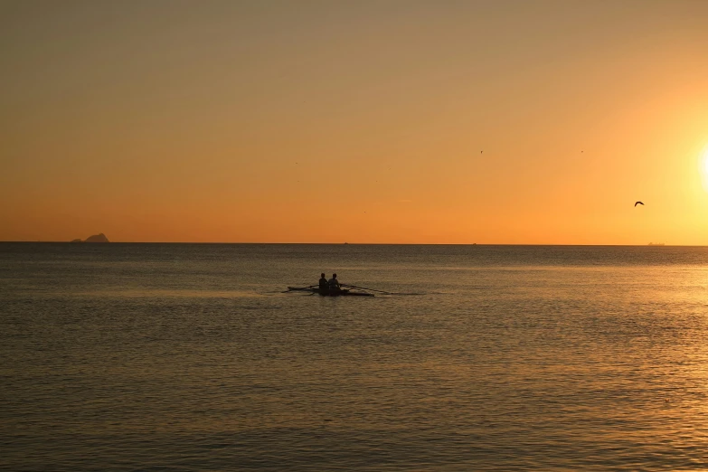 a person in a boat in the middle of the ocean, caulfield, ((sunset)), rowing boat, close together