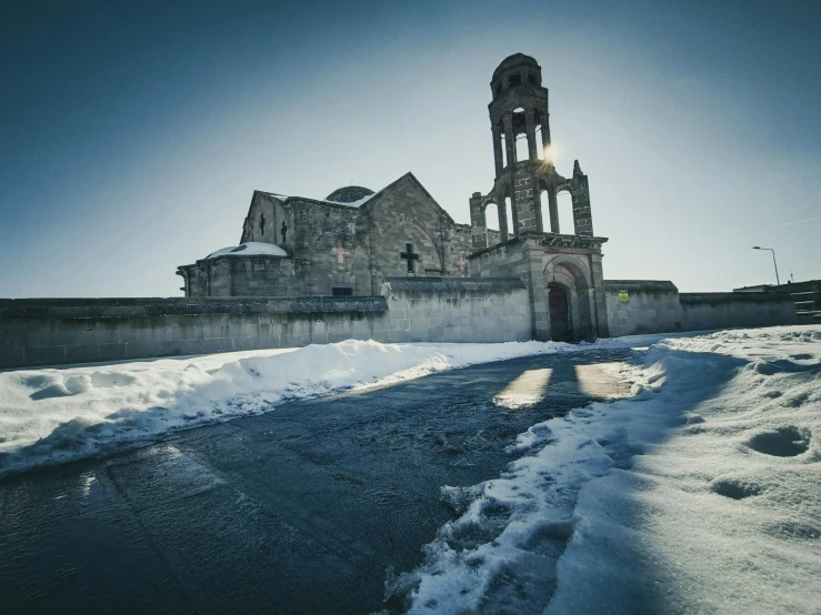 a church sitting in the middle of a snow covered field, an album cover, pexels contest winner, romanesque, citadel of erbil, dramatic cold light, abandoned streets, russian temple